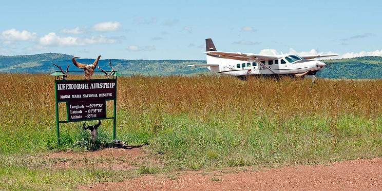 A small safari aircraft waiting at an airstrip in the Maasai Mara